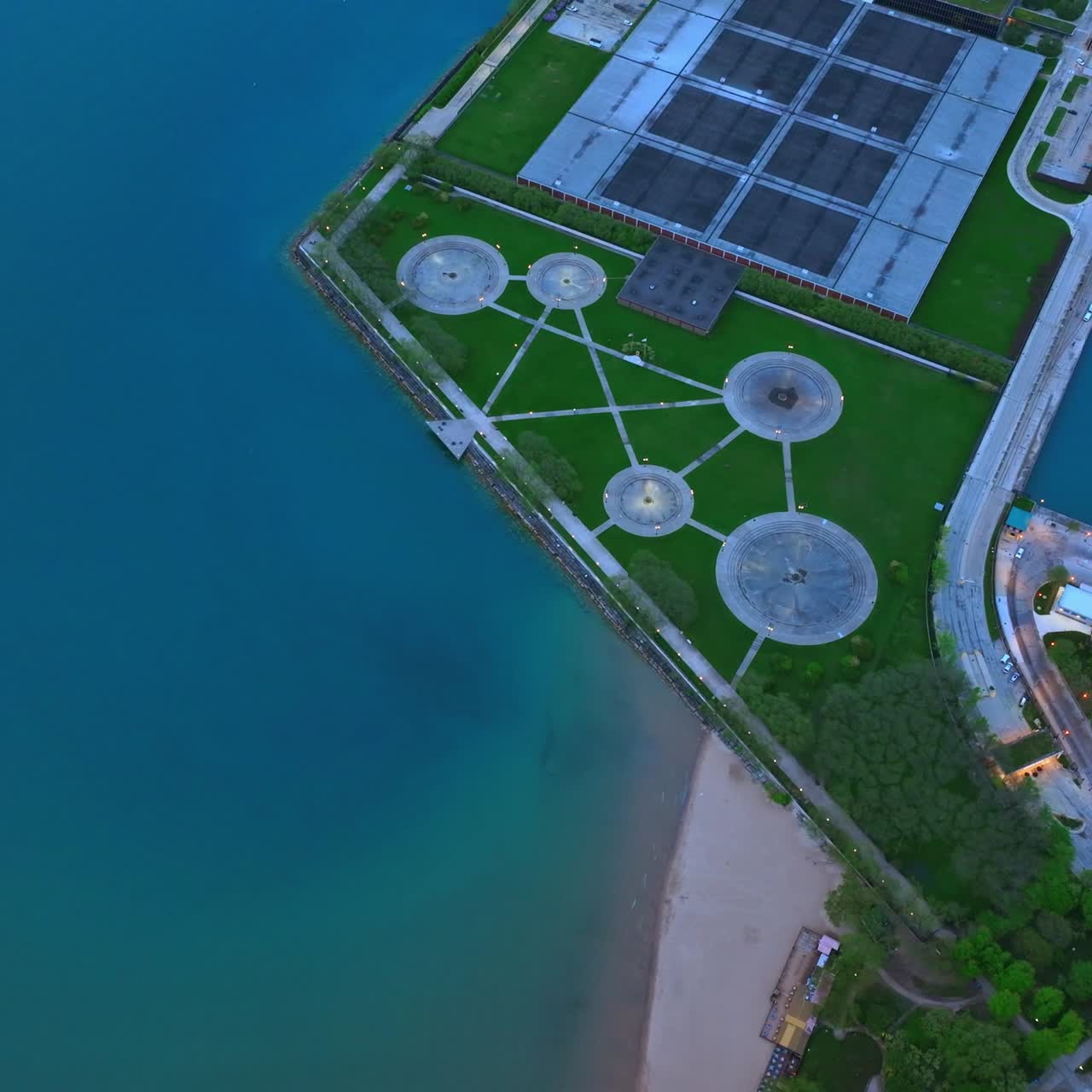 Lonely boat in the waters of Lake Michigan not far from waterfront. Green park locating at the bank. Chicago from aerial perspective