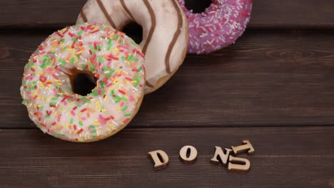 doughnuts covered with powdered sugar on wooden boards. set of sweet donuts