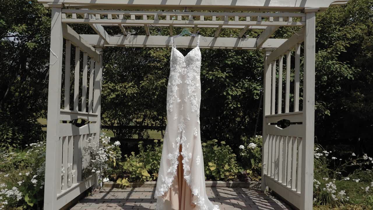Gorgeous designer dress hanging from a pergola at the Strathmere Wedding and Event center in Ottawa, Canada