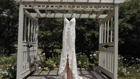 Gorgeous-designer-dress-hanging-from-a-pergola-at-the-Strathmere-Wedding-and-Event-center-in-Ottawa,-Canada