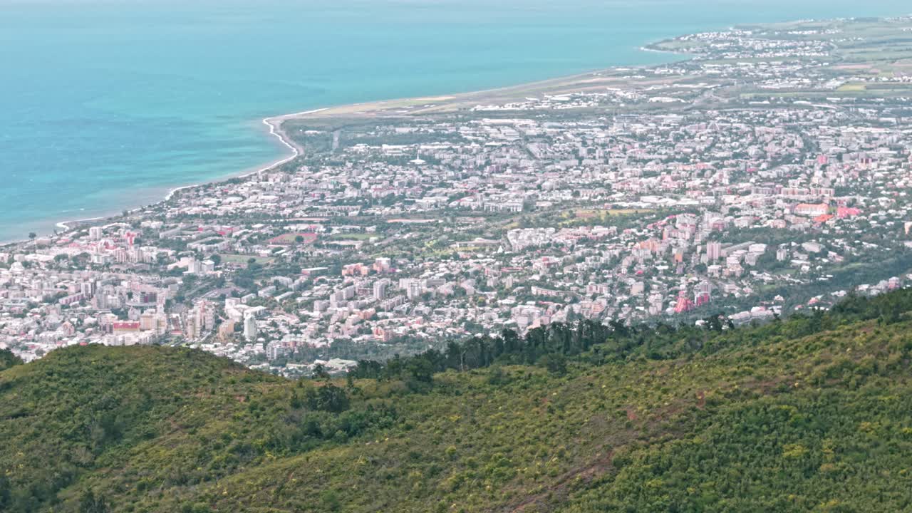 Saint Denis, La Reunion, aerial with city and coast in the background and hills in the foregound