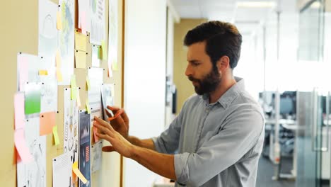 Male-executive-looking-at-bulletin-board