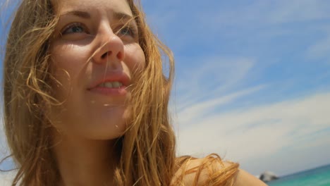 front view of caucasian woman standing with sarong on the beach 4k