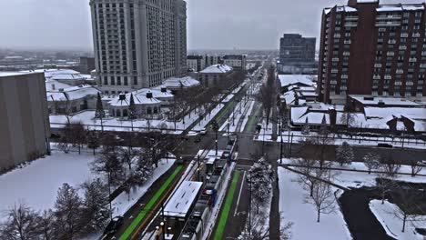 trax light rail system in a snowy downtown salt lake city, aerial view