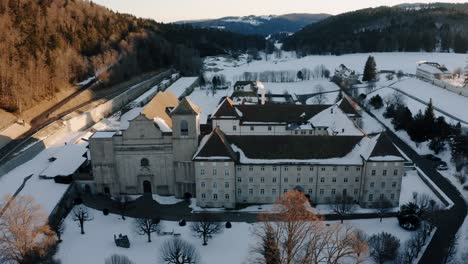 the abbey of bellelay, historical monument of the bernese jura in switzerland, aerial shot by drone during sunrise