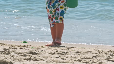 little boy playing near sea