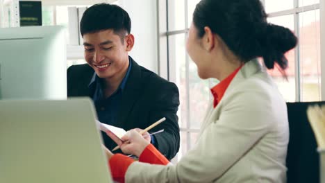 two business people talk project strategy at office