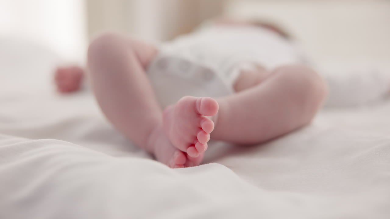 Sleeping, family and feet of baby on bed for child