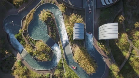 Aerial-zenithal-view-of-people-jumping-down-water-slides-at-the-resort-of-Hof-van-Saksen,-Nooitgedacht,-The-Netherlands