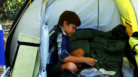 boy playing cards in the tent