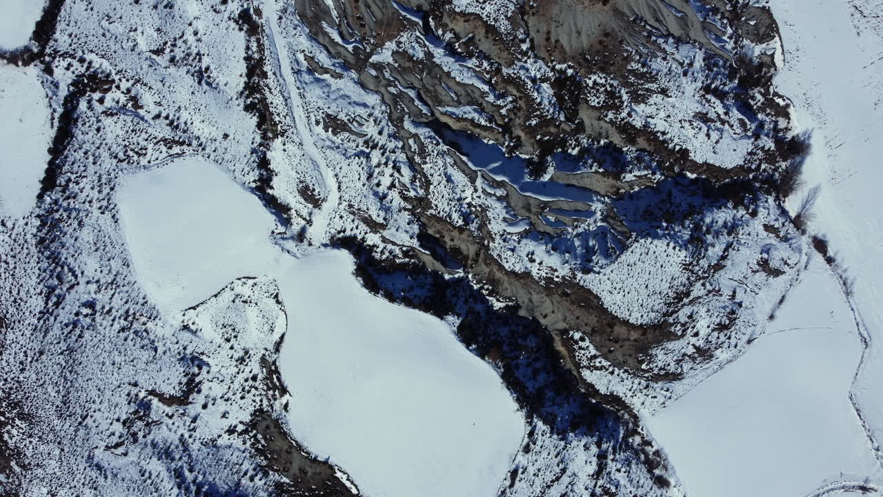 Snowy Eroded Terrain Aerial View