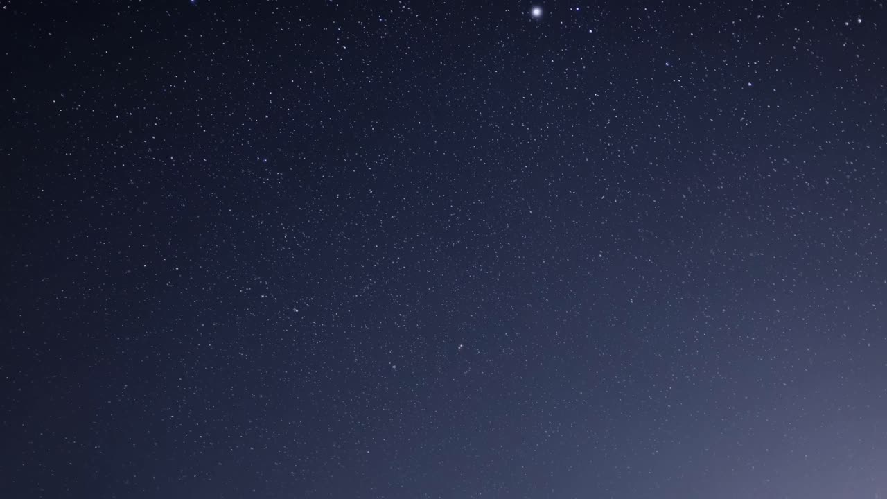 A mesmerizing video of a starry night sky, captured from a low-angle perspective, showcasing a vast