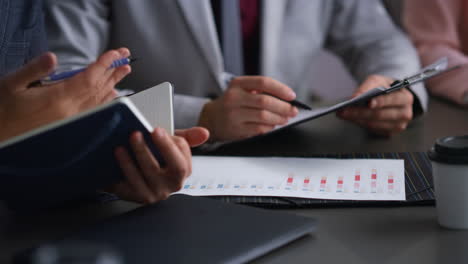 corporate colleagues fill forms in bank. businesspeople analyse paper in office