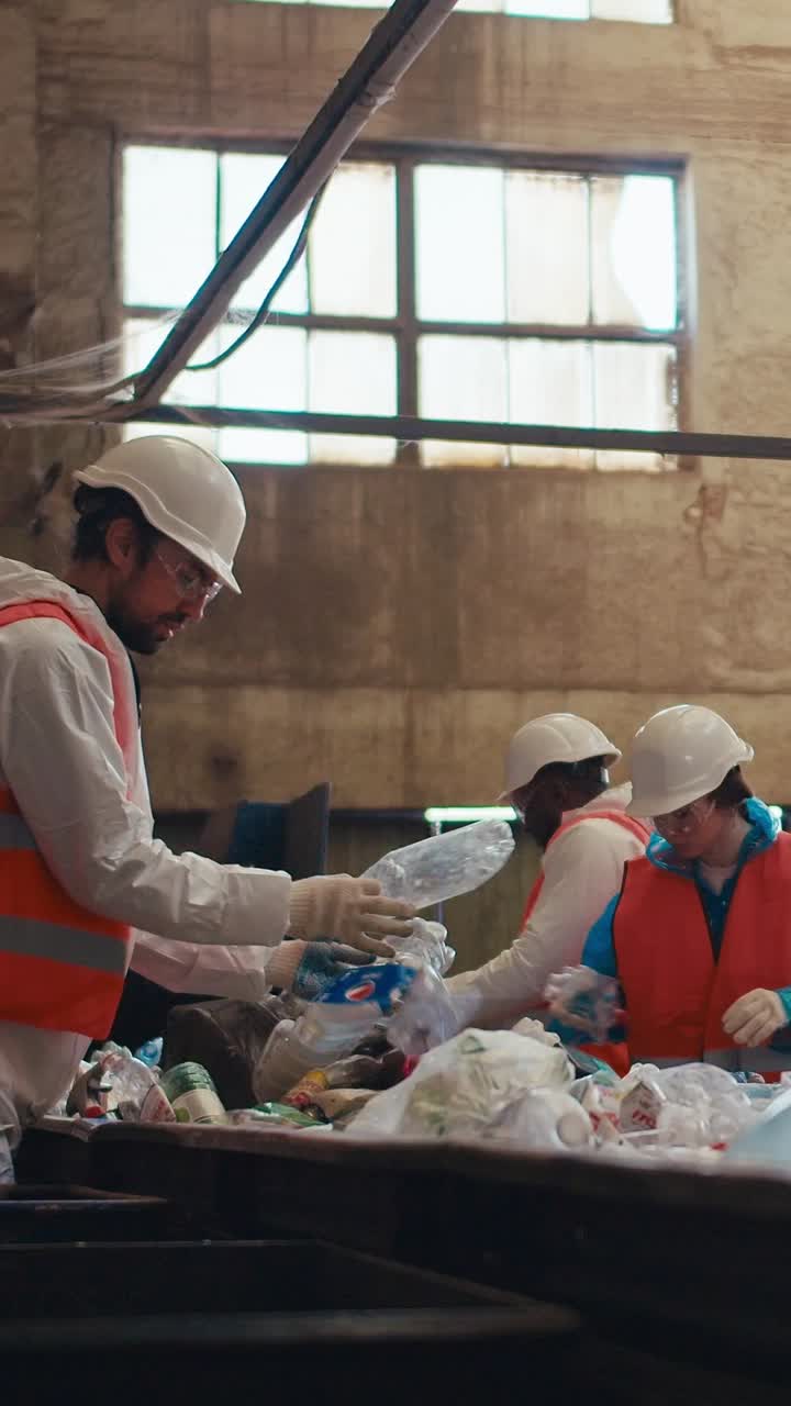 Recycling Plant Workers Sorting Waste