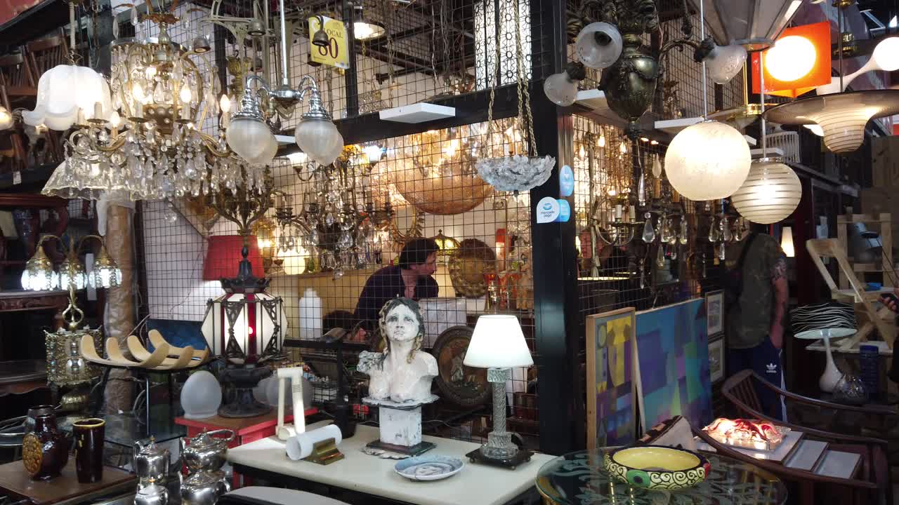 Flea market store with lamp and illumination decoration at Vintage store of buenos aires city, people and merchants