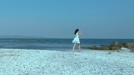 Toma-En-Cámara-Lenta-De-Una-Chica-Guapa-Con-Vestido-Blanco-Caminando-Por-La-Playa-5