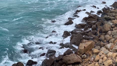 slow motion of sea waves crashing into a natural rock formation