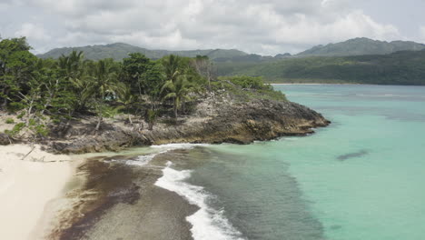 picturesque beach of playa rincon around las galeras, dominican republic on a cloudy day - aerial drone shot