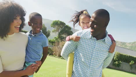 Video-of-happy-african-american-family-spending-time-together-in-the-garden