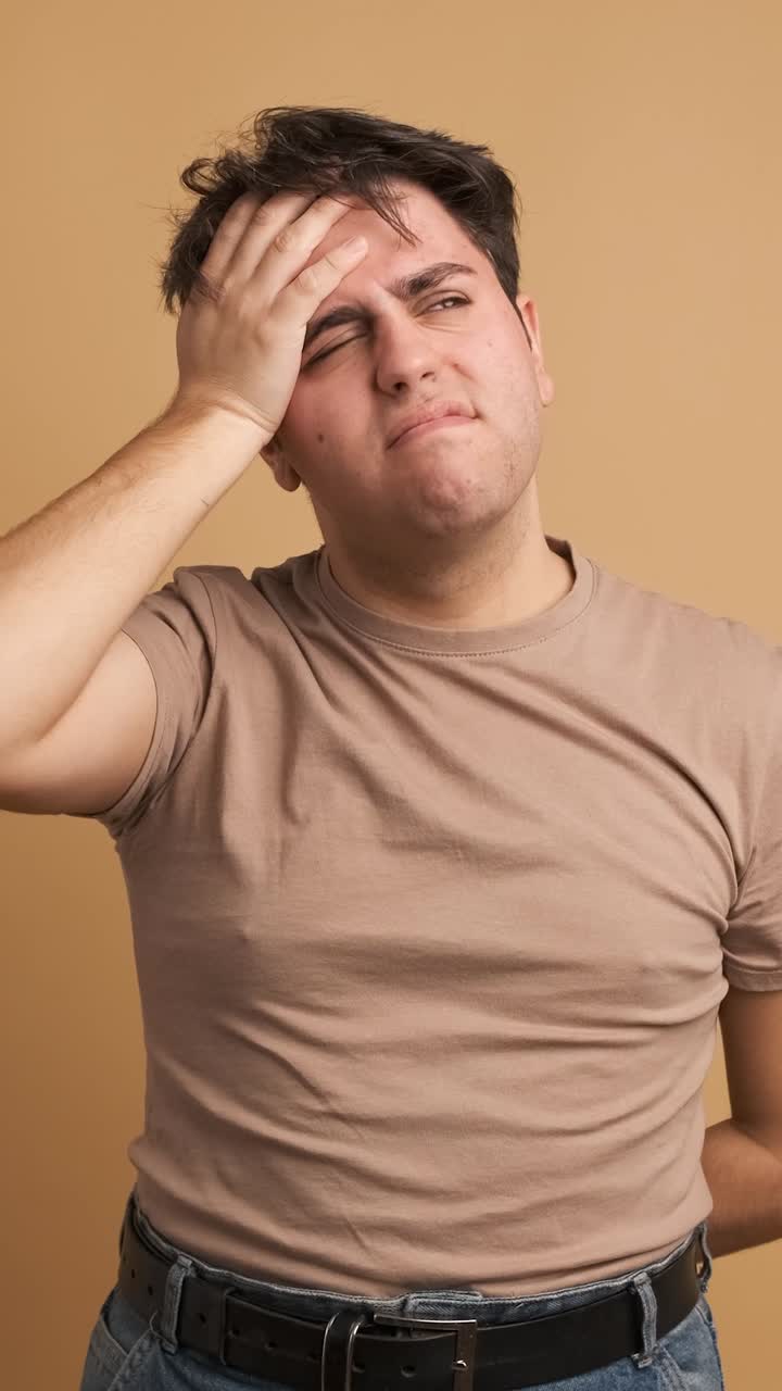 Young man feeling sick hands on head