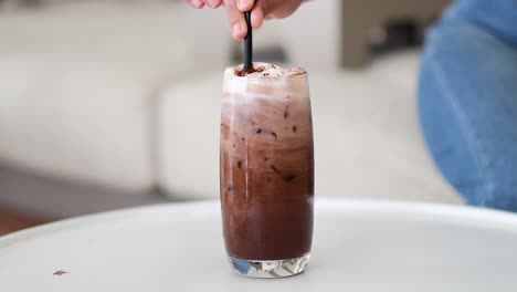 chocolate milk being poured into a clear glass