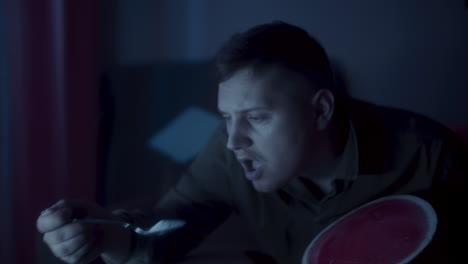 man eating watermelon at night