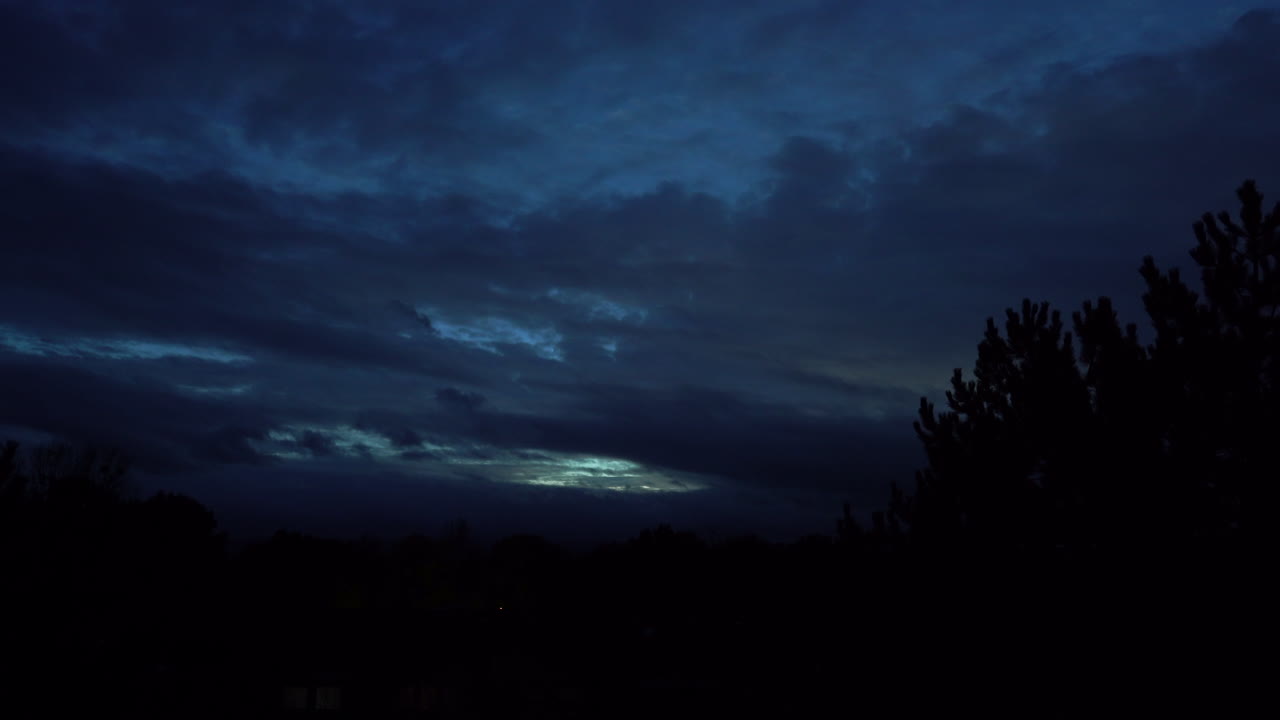 Dark Cloudy Sky with Light Breaking Through at Dusk