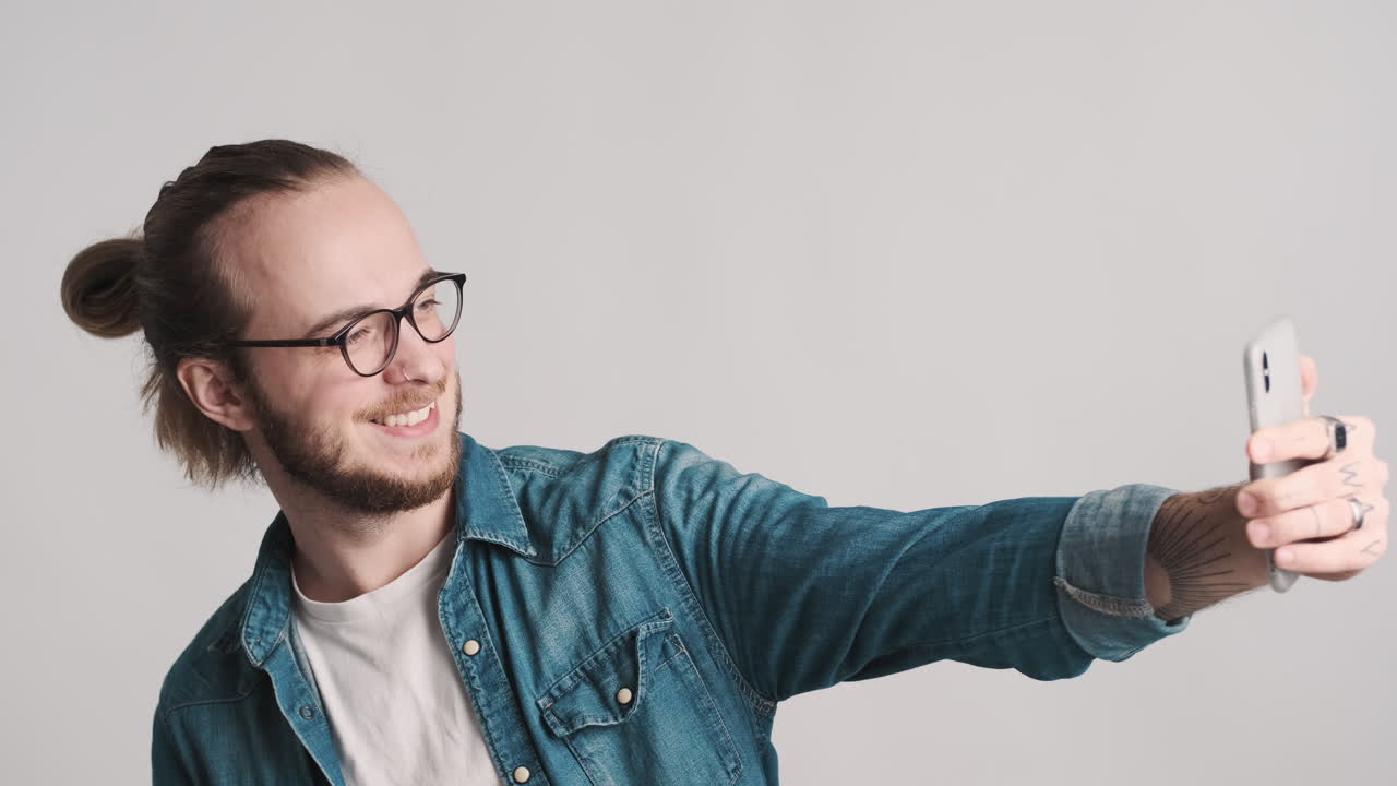 Giovane uomo caucasico che si scatta selfie con lo smartphone