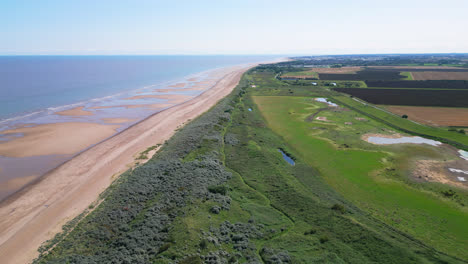 aerial footage captures the charm of a sunset in skegness, a quaint seaside town in the uk, highlighting the town, promenade, pier, and the scenic coastline