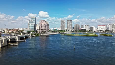 aerial: cityscape with royal park bridge, one flagler and phillips point building in west palm beach, florida, usa, pan down drone shot