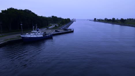 pushing west through the muskegon lake channel in the early gloomy morning