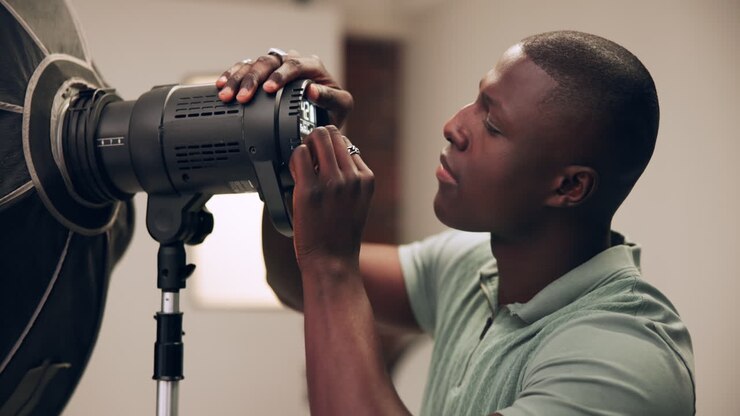 Photographer Adjusting Studio Lighting