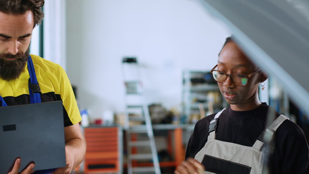 Coworkers doing car maintenance