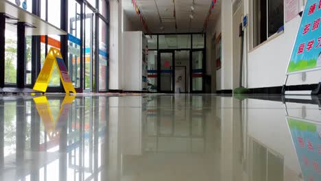 Static-low-angle-shot-of-a-clean-and-freshly-mopped-corridor-with-flags-of-different-countries-on-the-ceiling-on-a-beautiful-morning