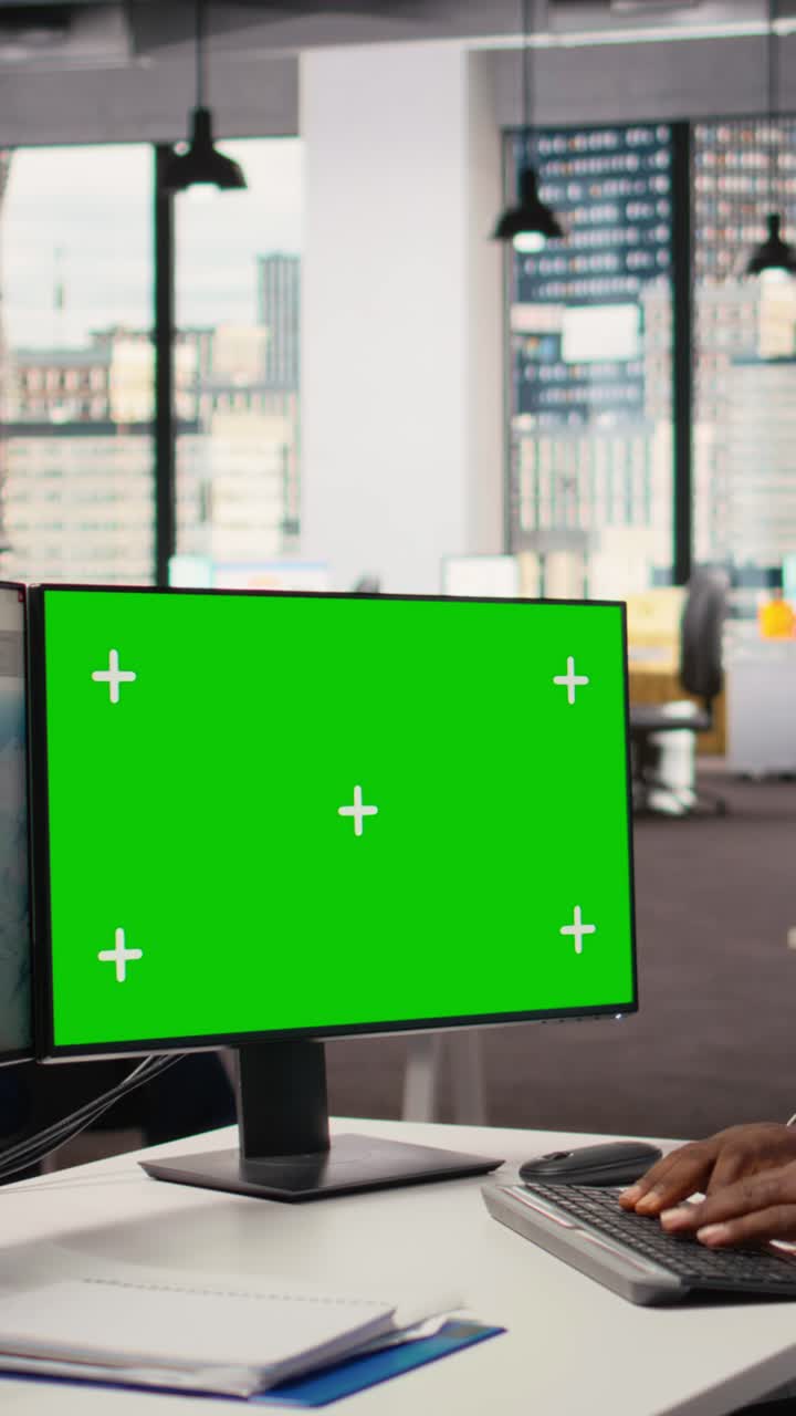 Technician works on wind turbine CAD design using green screen PC