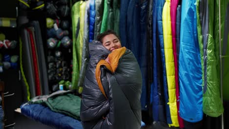 closeup of a woman covered in sleeping bag at tourist store