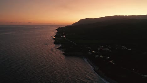 golden light glow of sunset along caribbean coastline, high angle view
