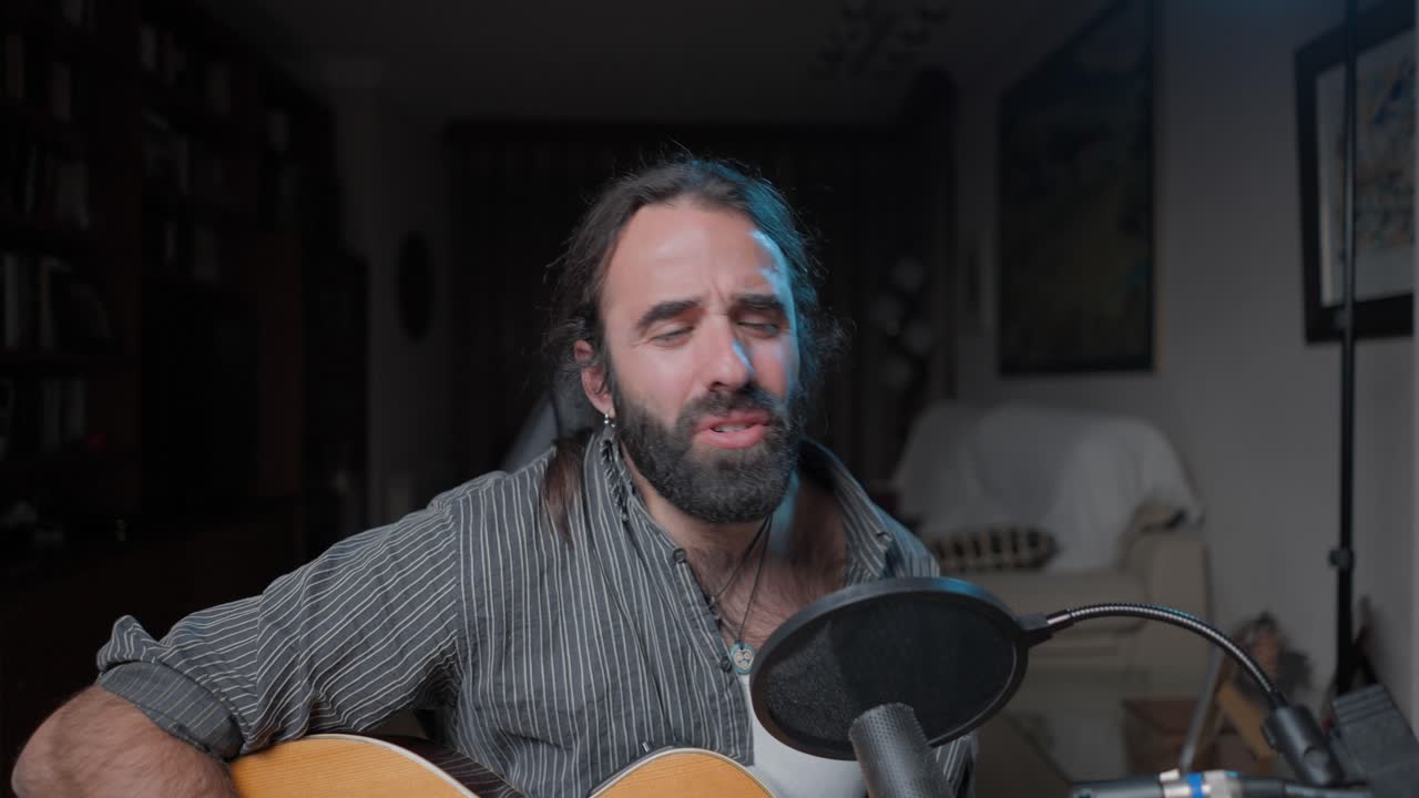 Man Singing and Playing Acoustic Guitar at Home