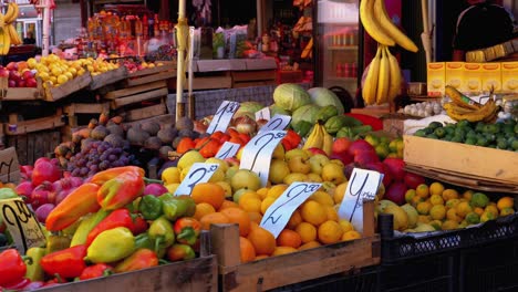 showcase with various fruits, persimmons, pomegranate, tangerines, pears and more in the street market