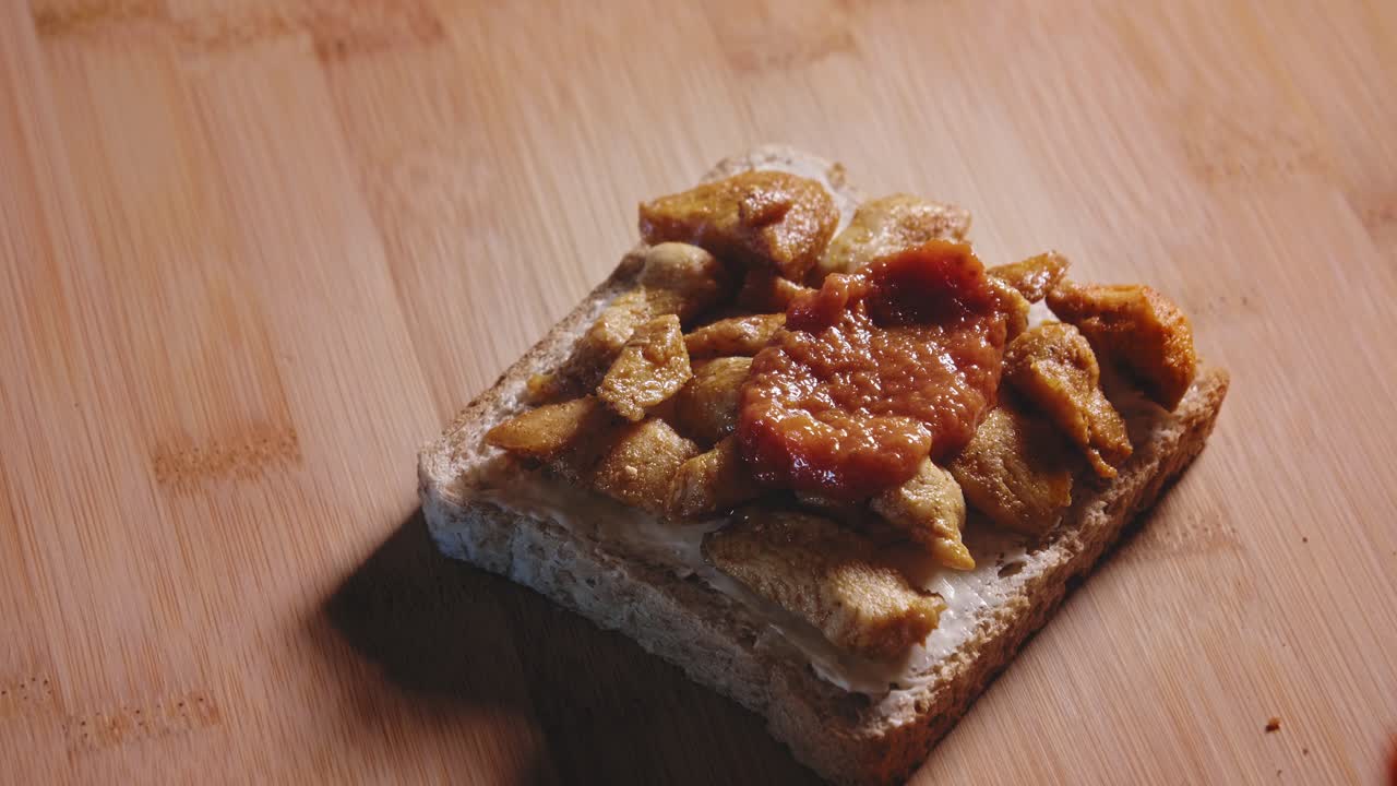 Putting Pizza Sauce On Top Of Fried Chicken Breast In Whole Grain Toast