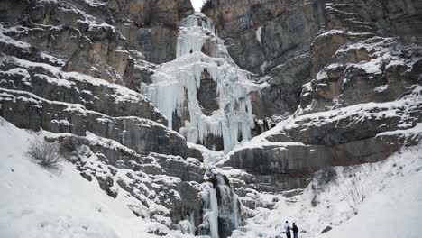 tilt up revealing the stunning frozen stewart falls waterfall near sundance ski resort in provo that requires a small hike to arrive to