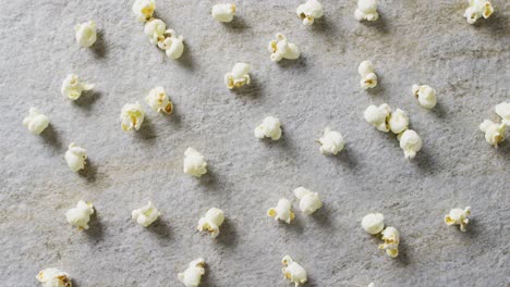 Video-of-close-up-of-popcorn-on-gray-background