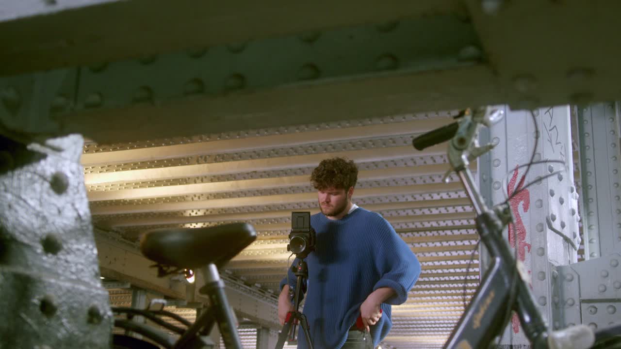 Man Setting An Analog Film Camera Indoors - wide
