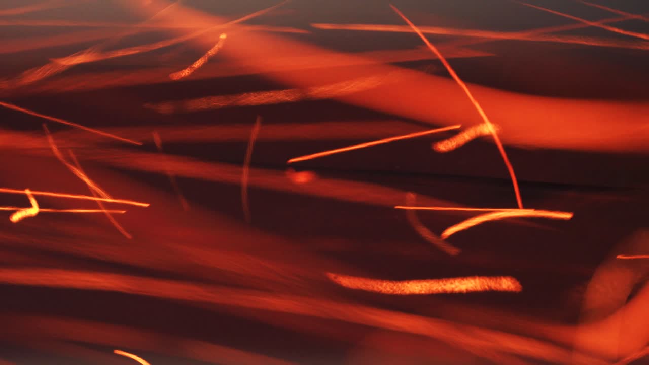 Flying burning hot particles of fire in a pipe at a factory. Beautiful abstract background on the theme of fire