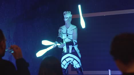 neon juggler performing