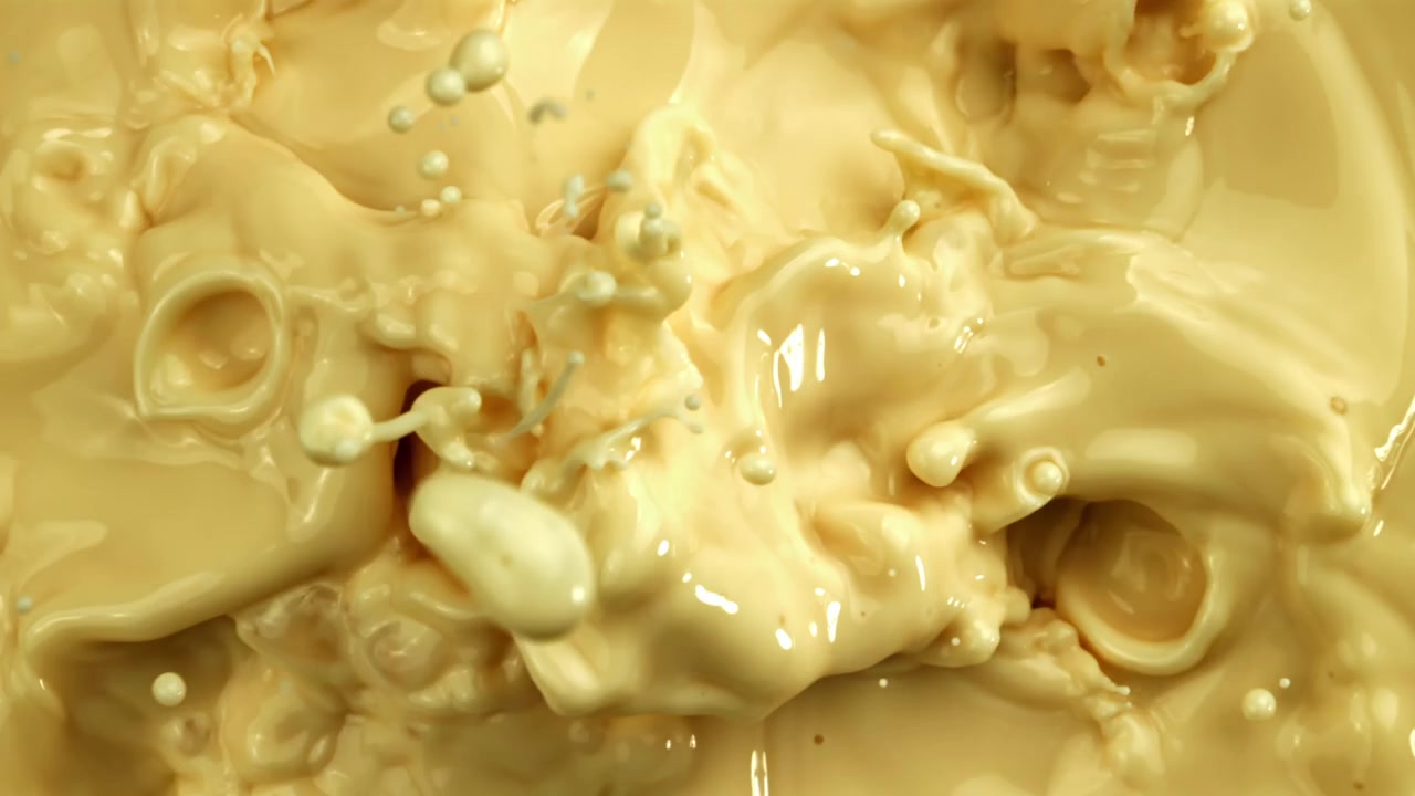 Dynamic Splashes and Ripples in Yellow Creamy Liquid