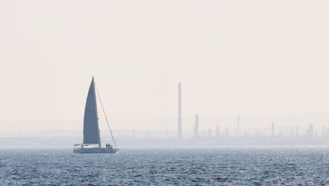 sailboat moving across the ocean near melbourne skyline