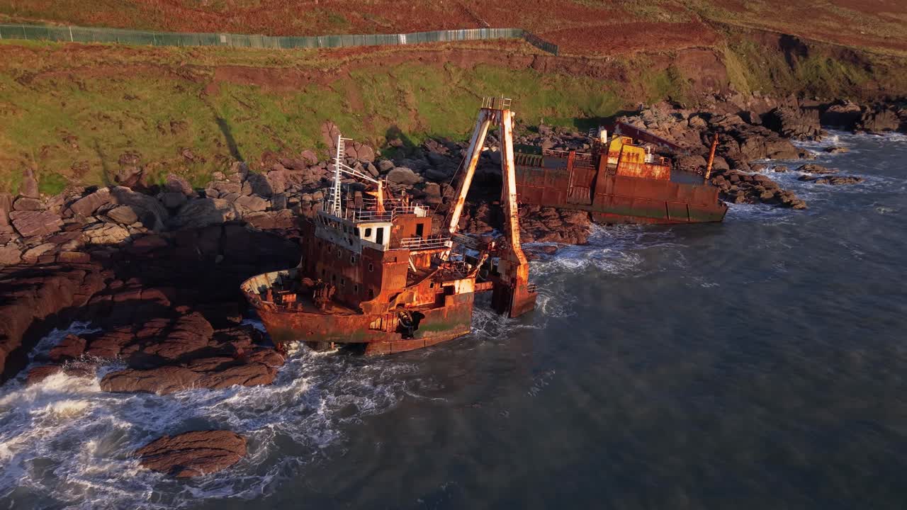 MV Alta Shipwreck Split in Half In Sunset By The Ballycotton Cliff Walk In Cork, Ireland. - aerial shot
