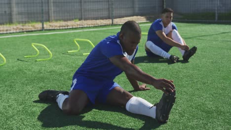 soccer players stretching on field