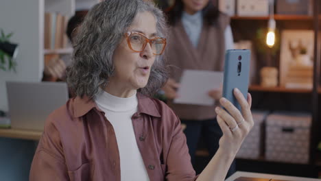 senior woman on video call in office